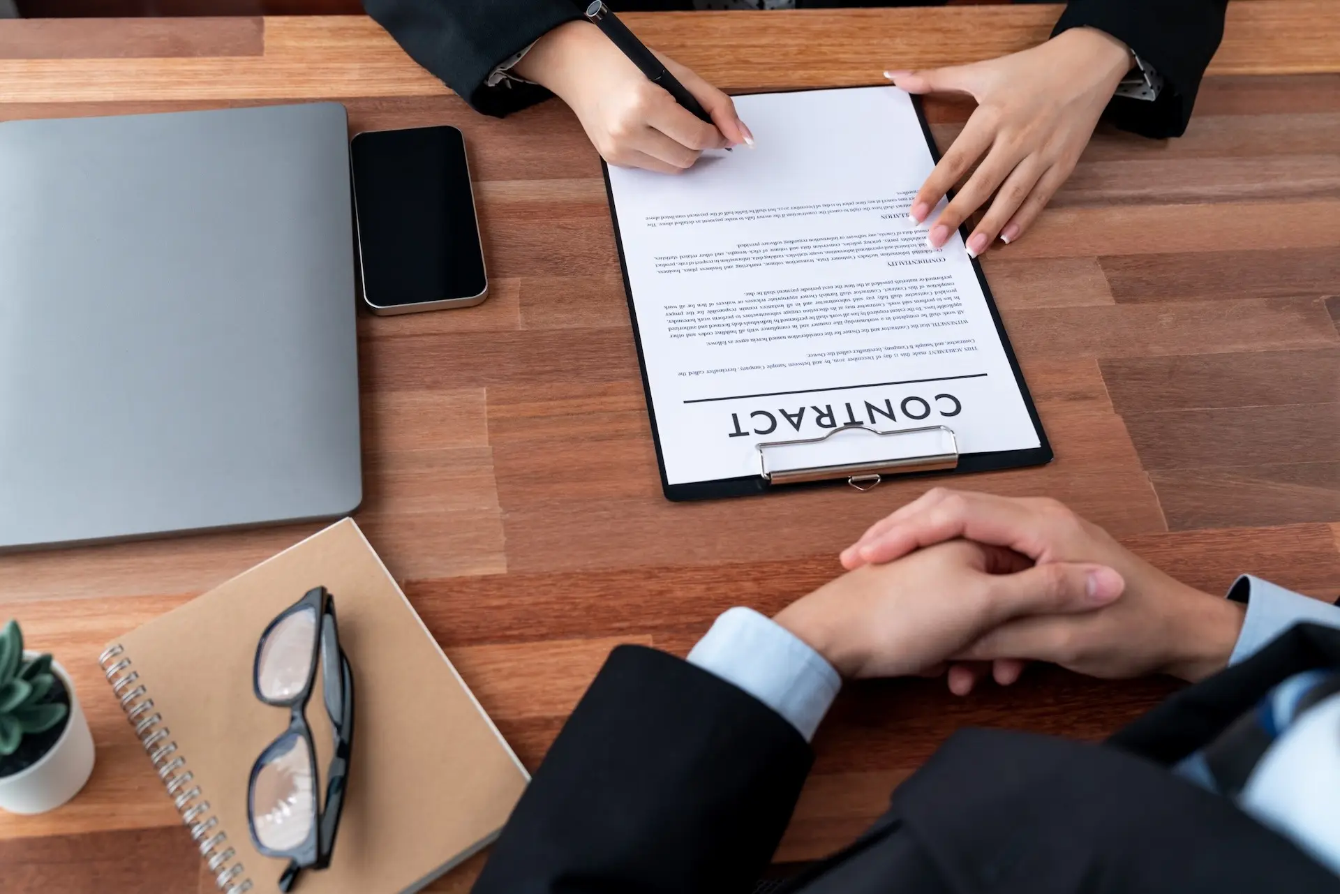 fixed-term-employment-contract Executives sign contract in meeting room. Business people seal deal on paper. Successful agreement between two business partnership with signature signed on legal document. Jubilant